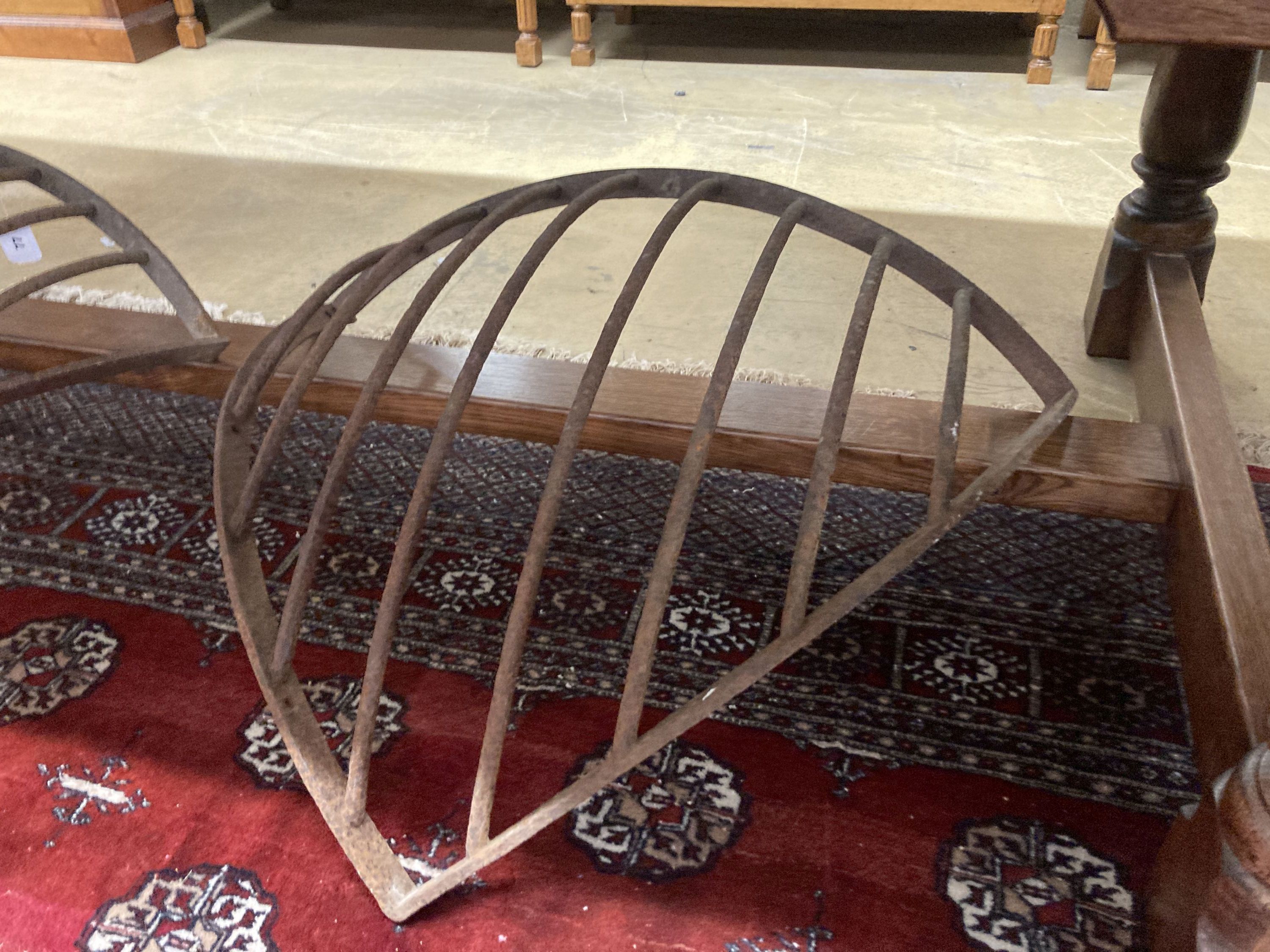 A pair of wrought iron corner stable mangers, each 80cm wide, height 76cm